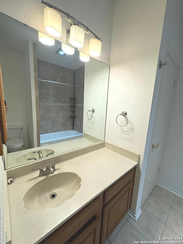 full bathroom with vanity, toilet, tiled shower / bath combo, and tile patterned floors