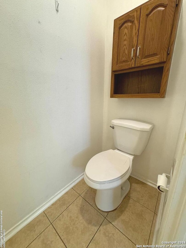 bathroom featuring toilet and tile patterned floors