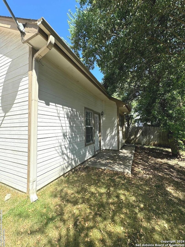 view of home's exterior with a lawn