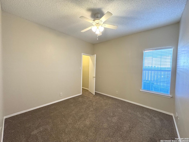 carpeted spare room featuring a textured ceiling and ceiling fan