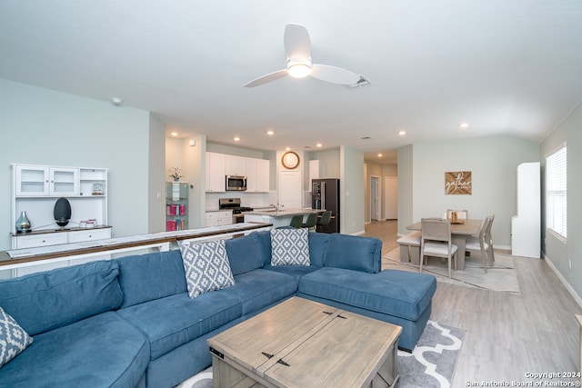 living room featuring light wood-type flooring and ceiling fan