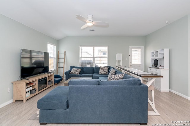 living area featuring plenty of natural light, light wood finished floors, and ceiling fan