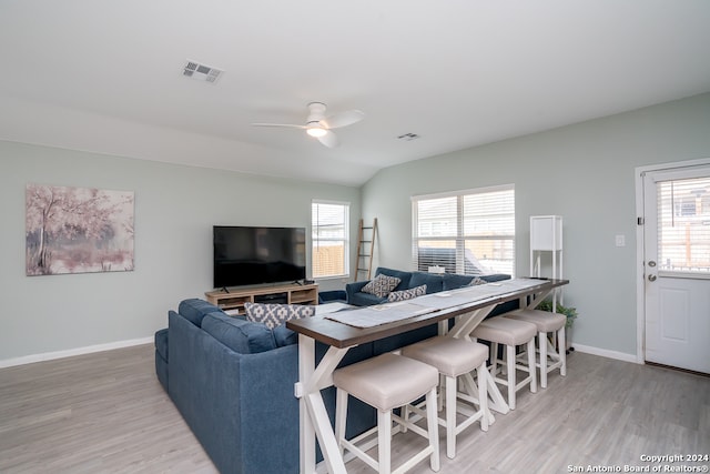 living room featuring ceiling fan and light hardwood / wood-style floors