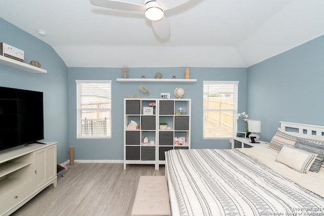 bedroom featuring lofted ceiling, baseboards, ceiling fan, and light wood finished floors