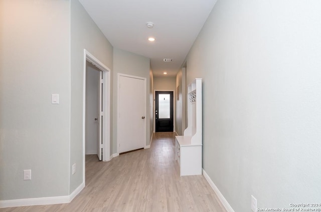 corridor with recessed lighting, light wood-type flooring, and baseboards