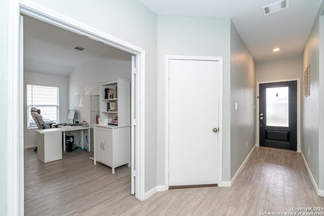 interior space with light wood finished floors, baseboards, visible vents, and recessed lighting