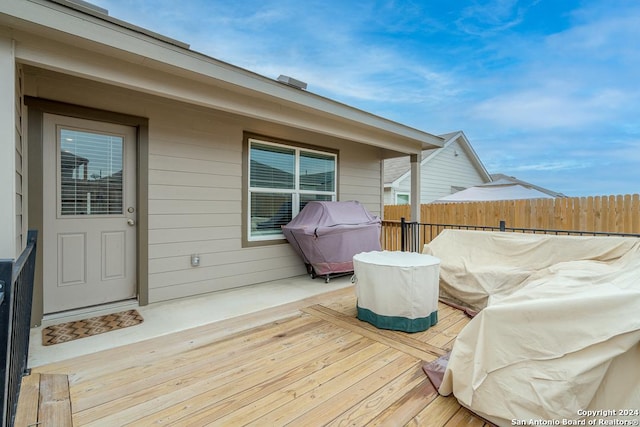 wooden terrace with fence and area for grilling