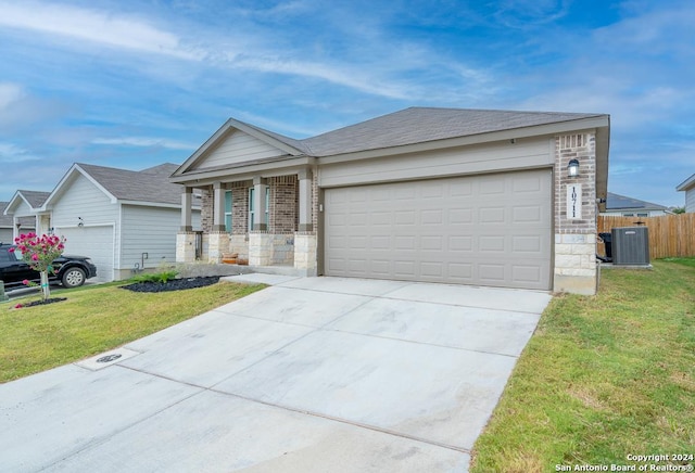 ranch-style home with an attached garage, fence, a front lawn, and cooling unit