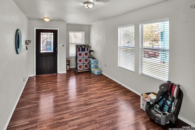 entryway featuring a textured ceiling and dark hardwood / wood-style flooring