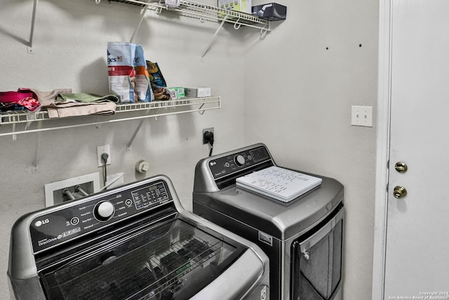 clothes washing area with washer and clothes dryer