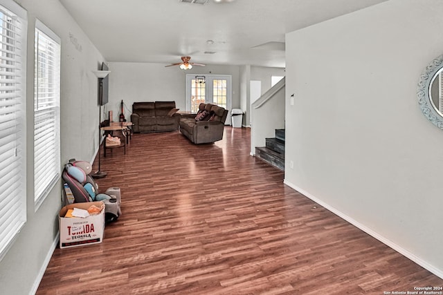 living room with ceiling fan and dark hardwood / wood-style floors