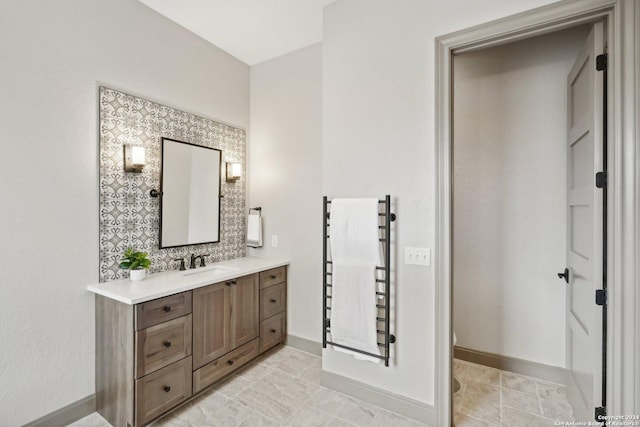 bathroom featuring vanity and decorative backsplash