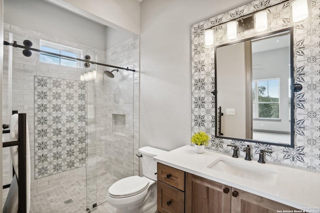 bathroom with toilet, vanity, and walk in shower