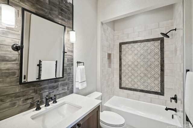 full bathroom featuring tiled shower / bath, vanity, toilet, and decorative backsplash