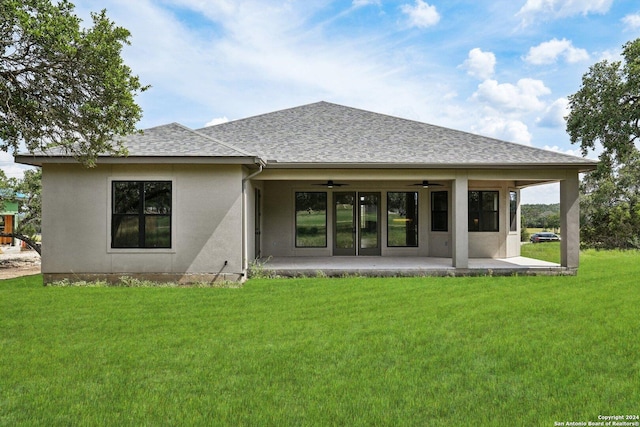 back of house featuring ceiling fan, a yard, and a patio area