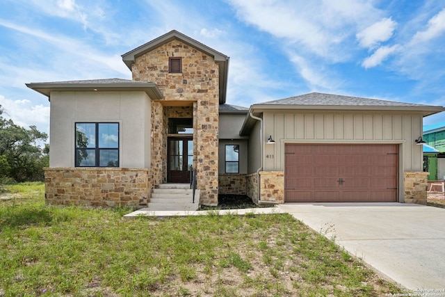 view of front of home featuring a garage and a front lawn