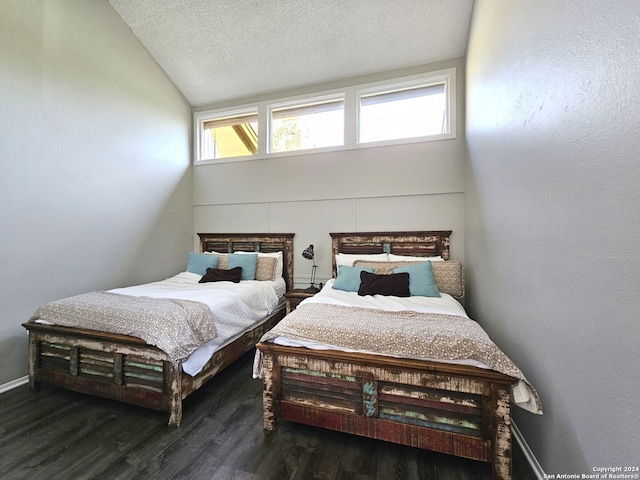 bedroom featuring high vaulted ceiling, a textured ceiling, and hardwood / wood-style floors