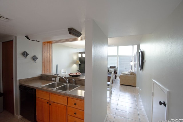 kitchen featuring sink, dishwasher, and light tile patterned floors