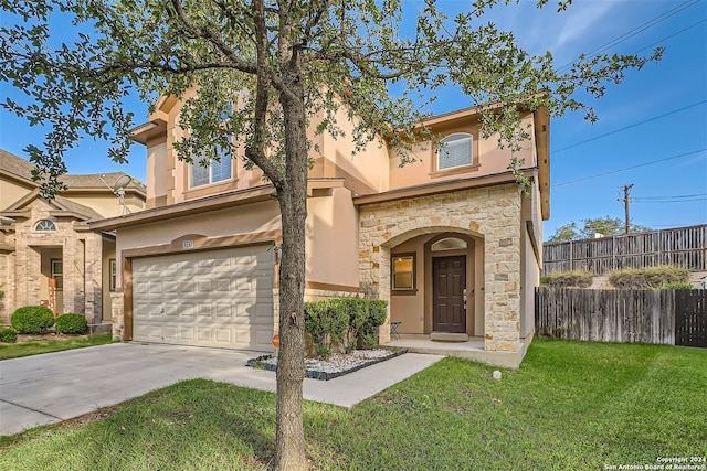 mediterranean / spanish-style house with a garage and a front lawn