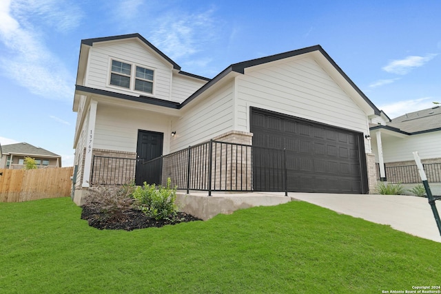 view of front of property with a garage and a front lawn