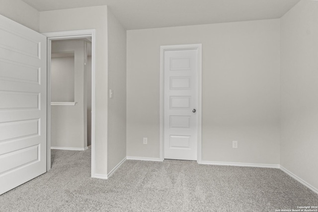 unfurnished bedroom featuring light colored carpet