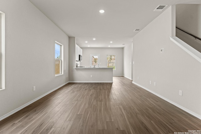 unfurnished living room with hardwood / wood-style floors