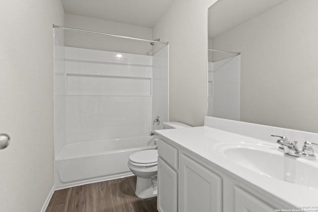 full bathroom with vanity, hardwood / wood-style floors,  shower combination, and toilet