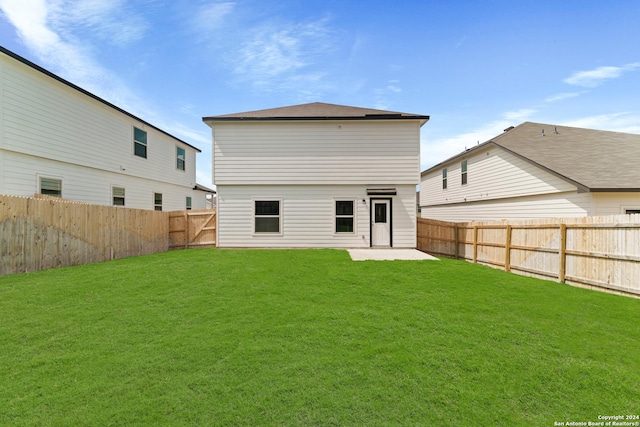 rear view of property with a patio and a yard