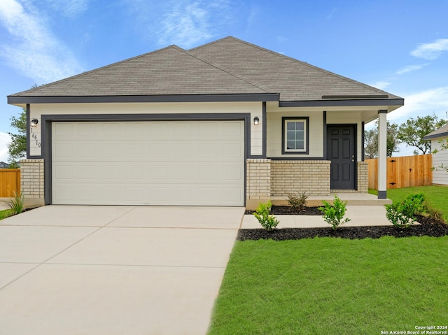 view of front of house featuring a front yard and a garage