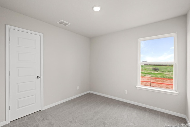 empty room featuring light carpet