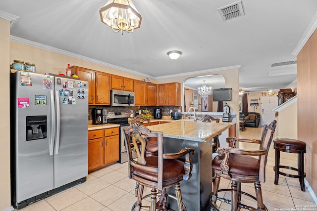 kitchen featuring hanging light fixtures, light tile patterned floors, stainless steel appliances, and an inviting chandelier