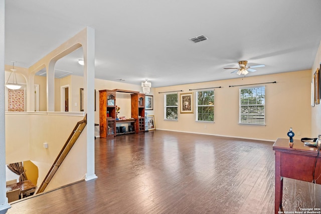 living room with ceiling fan and dark hardwood / wood-style flooring