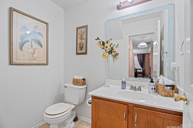 bathroom featuring toilet, vanity, and tile patterned flooring