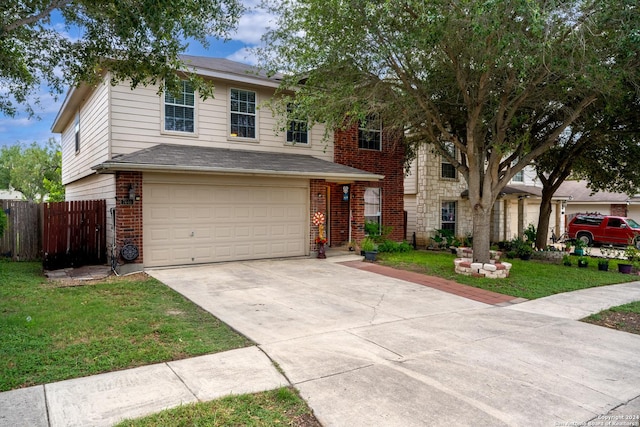 view of front of house with a garage and a front lawn