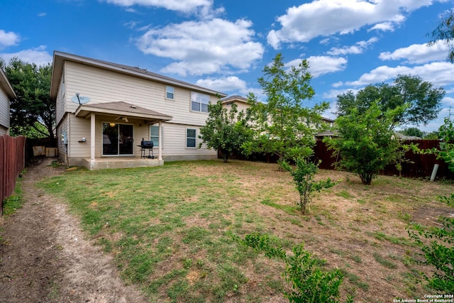 rear view of property with a yard and a patio