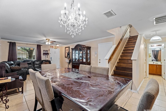 dining area with ceiling fan with notable chandelier, light tile patterned flooring, and crown molding