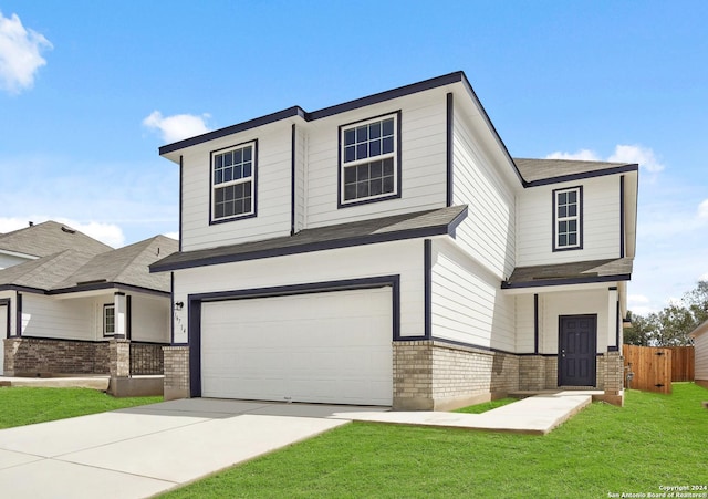 view of front facade featuring a garage and a front lawn