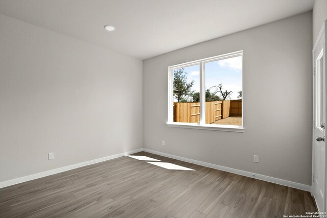 spare room featuring hardwood / wood-style floors