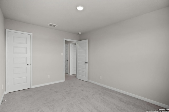 unfurnished bedroom featuring light colored carpet