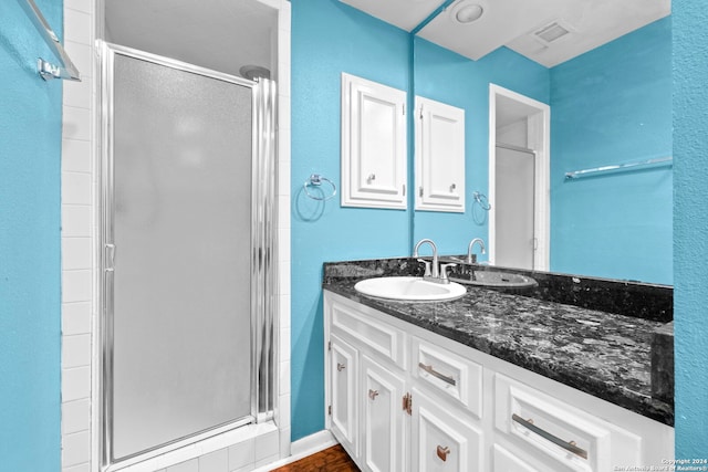 bathroom with vanity and an enclosed shower