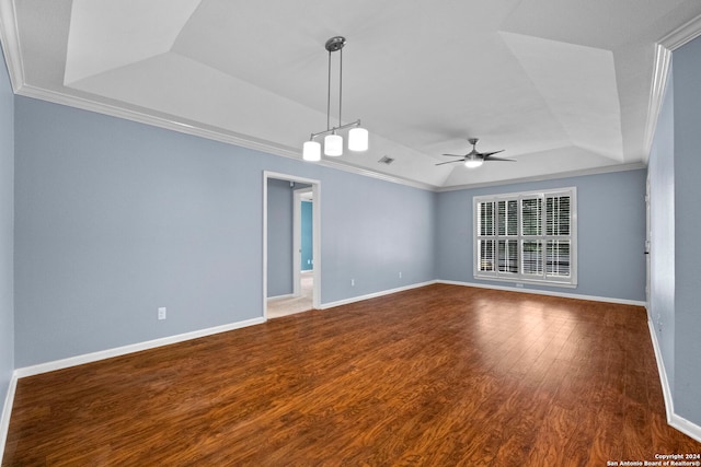 unfurnished room featuring a tray ceiling, ceiling fan, ornamental molding, and hardwood / wood-style flooring