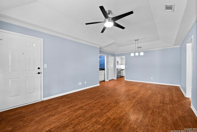 unfurnished living room featuring a tray ceiling, vaulted ceiling, ceiling fan, crown molding, and hardwood / wood-style flooring