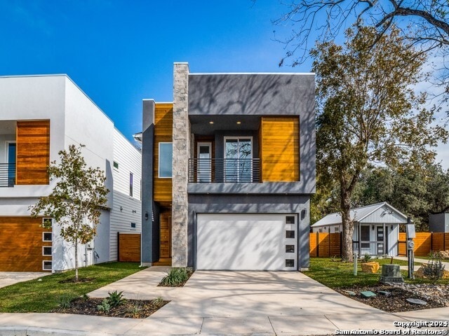 contemporary home featuring a balcony and a garage