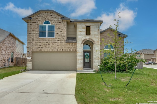 view of front facade with a garage and a front yard