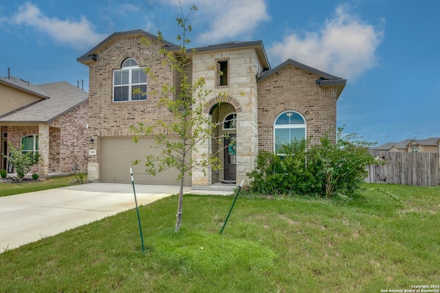 view of front of property with a garage and a front yard