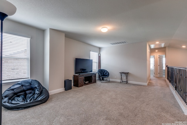 carpeted living room featuring plenty of natural light