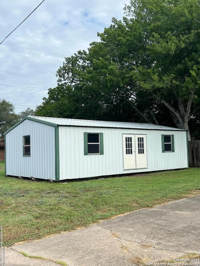 view of outbuilding with a lawn