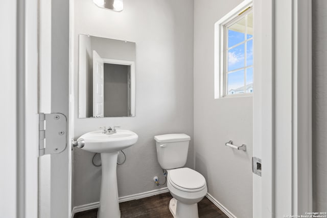 bathroom featuring sink, hardwood / wood-style floors, and toilet