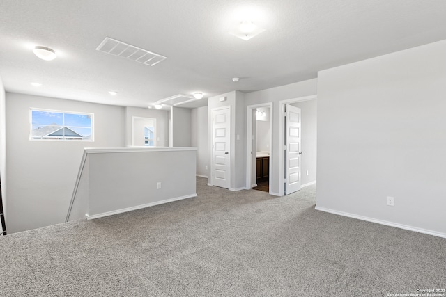 basement with a textured ceiling and carpet