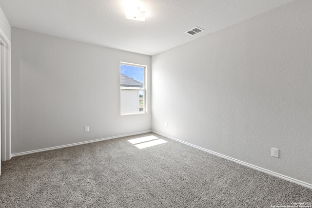 unfurnished room featuring carpet